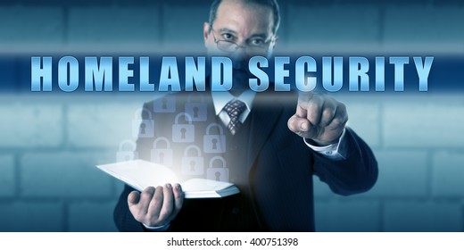 Governmental Protection Professional Is Pushing HOMELAND SECURITY On A Virtual Touch Screen. Business Metaphor And Security Industry Concept For Emergency Preparedness And Threat Prevention.