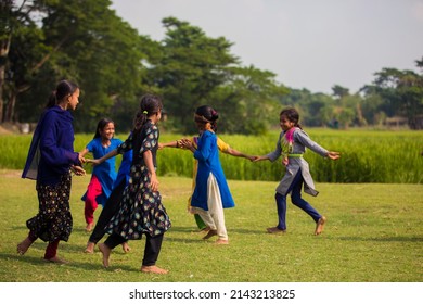 Gowainghat, Bangladesh – November 06, 2019: Children Enjoying Blind Man’s Bluff Game In The Leisure Time On School Playground. Young Girls Playing Blind Mans Bluff In The Village