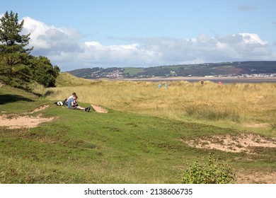 Gower, Wales, UK: September 16, 2016: Ramblers take a rest in the sunshine during a coastal walk along the north Gower coast overlooking Loughor estuary.