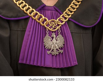 Gown of a judge in Poland with a purple jabot.  On it hangs a judge's chain with gold eyelets and a silver white eagle - Shutterstock ID 2300082133