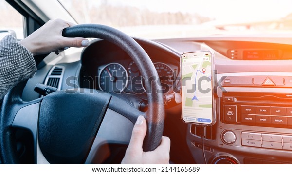 Gps car map system. Global positioning system on\
smartphone screen in auto car on travel road. Navigation auto\
location system app