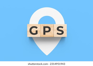 GPS (Global Positioning System) wooden cubes on blue background  - Shutterstock ID 2314951943