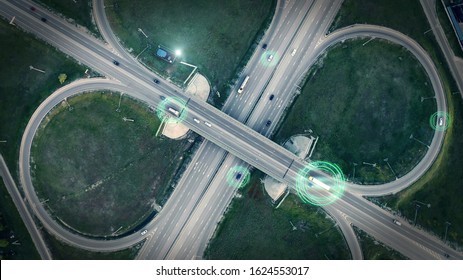 GPS navigation and autonomous driverless transportation concept. Aerial view of transport junction with cars and trucks driving with digital green circles, future global technology on roads.