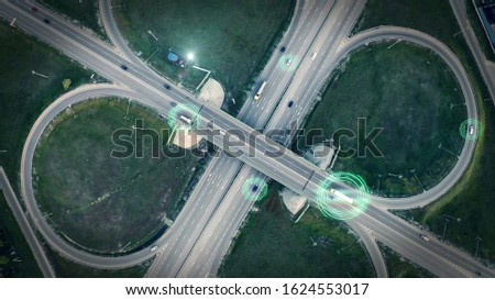 GPS navigation and autonomous driverless transportation concept. Aerial view of transport junction with cars and trucks driving with digital green circles, future global technology on roads.