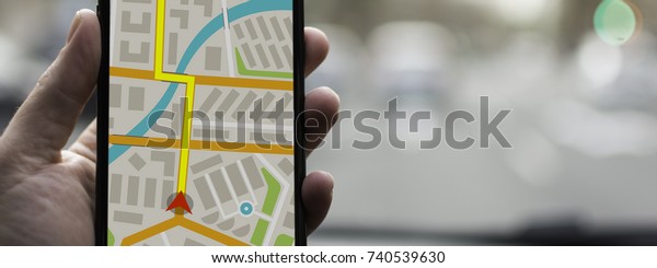GPS Navigation on Mobile Phone Device and\
Transportation Concept. Male Hand Using Navigation System Map\
Tracking on Smartphone with Copy\
Space.