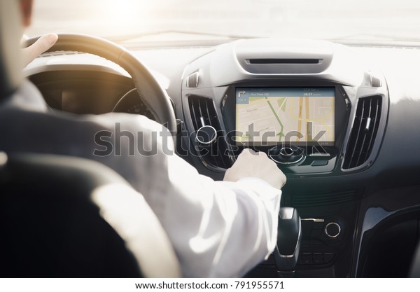 GPS navigation system. Person driving a car\
with satellite navigation.