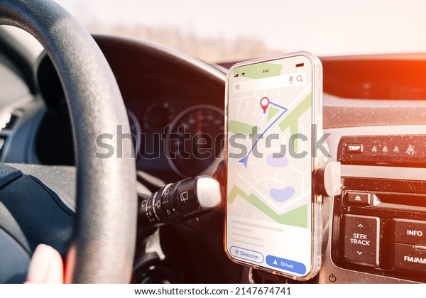 Gps navigator map system. Global positioning\
system on smartphone screen in auto car on travel road. GPS car\
search location technology