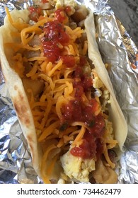 Grab A Austin , Texas Tex-mex Flour Tortilla BreakFast Taco With Scrambled Eggs, Cheese, Potatoes  On Foil 