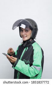 Grab Driver Asian Woman With Helmet Holding Smartphone. November 10, 2020. Jakarta Indonesia
