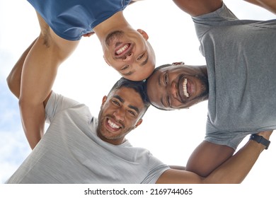 Grab a friend and have fun making gains. Low angle shot of a group of sporty young people joining their heads together in a huddle outdoors.
