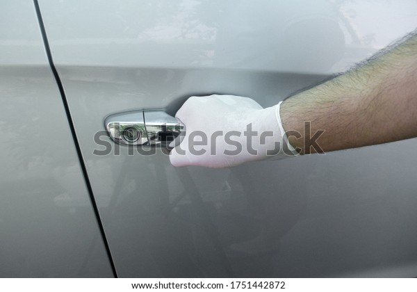 grabbing car handle using gloves\
