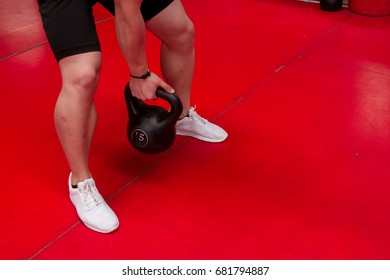 Grabbing A Dumbells Whit White Shoes On A Red Carpet