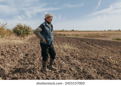 Graceful Aging The photo beautifully portrays an old and wise farmer, his weathered face reflecting years of toil and dedication, standing proudly amidst the flourishing crops. - Powered by Shutterstock