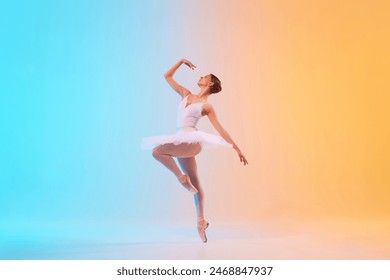 Graceful classic ballerina in white tutu on pointe dancing in motion in neon light against blue-orange gradient background. Concept of art, movement, classical and modern fusion, beauty and fashion. - Powered by Shutterstock