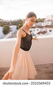 A Graceful Young Dancer Posing Elegantly on a Beautiful Balcony at Glorious Sunset Time