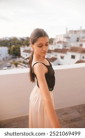 A Graceful Young Dancer is Posing Elegantly on a Beautifully Sunlit Balcony Space