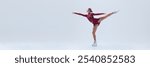 Graceful young girl in deep red stage costume making creative and artistic performance, figure skater in moon isolated on white background. Concept of professional sport, movement. Copy space for ad