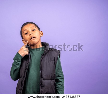 Grade School Hispanic Boy points to his jaw with room for copy on the right