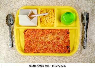 Grade School Lunch Tray With Pizza With Small Carton Of Milk Mac-n-cheese And Green Gelatin For Dessert