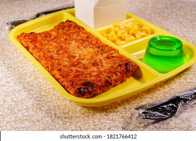 Grade School Lunch Tray With Pizza With Small Carton Of Milk Mac-n-cheese And Green Gelatin For Dessert