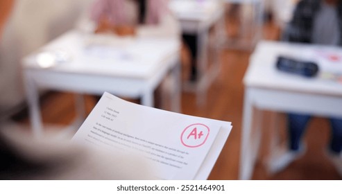 Grade, school and teacher with results, closeup and academic with education. Success, achievement or evaluation with documents, learning or studying with positive feedback or development in classroom - Powered by Shutterstock