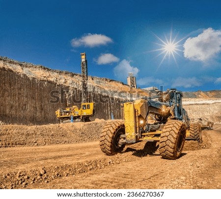 grader and drilling rig ,digging and loading kimberlite at the plant in the diamond mine ,daytime.