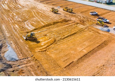 Grader excavators are remove layer of soil at construction site project in progress of leveling land