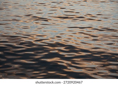 Gradient abstract composition of circular waves and various flowing shapes, enlightened by rose golden hues