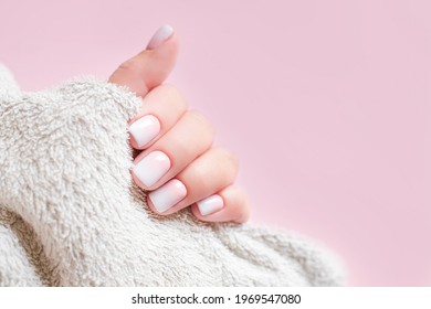 Gradient manicure   Hands Spa  Beautiful Woman hand closeup  Manicured nails   Soft hands skin  Beautiful woman's nails and beautiful baby boomer manicure  pink background  Copy space 