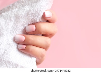 Gradient manicure   Hands Spa  Beautiful Woman hand closeup  Manicured nails   Soft hands skin  Beautiful woman's nails and beautiful baby boomer manicure  pink background  Copy space 