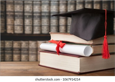 Graduate Cap And Book In Library