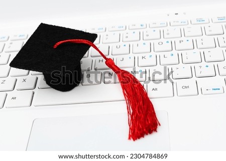 Graduate cap on laptop keyboard