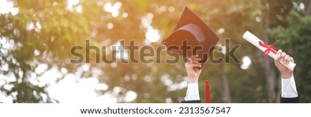 graduate are celebrating graduation. Happiness feeling hand hold show hat and diploma certificate in background sky.  Congratulation education during Commencement day University Degree. 