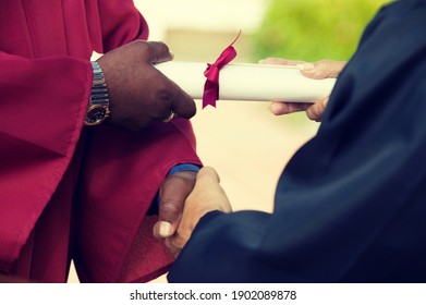 Graduate Receiving Diploma and Handshake