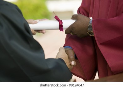 Graduate Receiving Diploma And Handshake