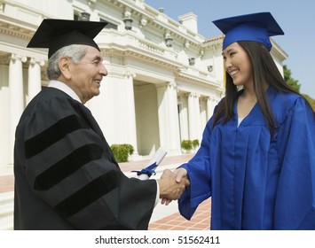 Graduate Shaking Hand Of Dean Outside University, Side View