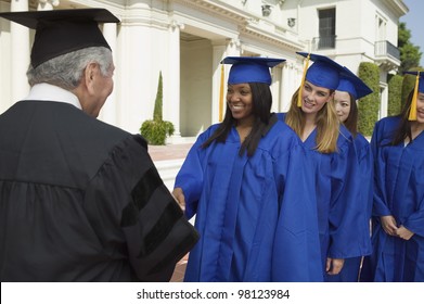 Graduate Shaking Hands And Receiving Diploma