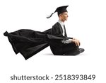 Graduate student in a gown sitting on the ground isolated on white background