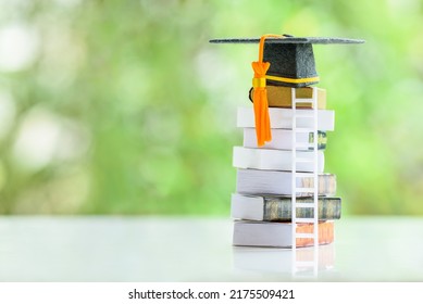 Graduate study abroad program to broaden learner's world view, education concept Graduation cap, foreign books on a table, depicting students attempt to study from a distance or learning from home. - Shutterstock ID 2175509421