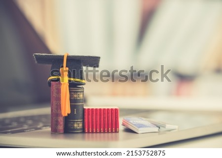 Graduate study abroad program to broaden learner's world view, e-learning concept Graduation cap, foreign books on a laptop, depicts student attemptong to study from a distance or learning from home.