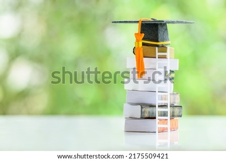Graduate study abroad program to broaden learner's world view, education concept Graduation cap, foreign books on a table, depicting students attempt to study from a distance or learning from home.