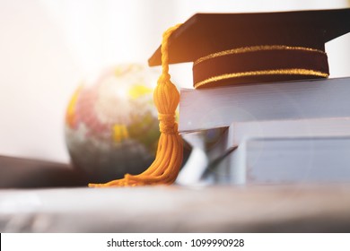 Graduated Or Graduation University Study Abroad International Conceptual, Master Cap On Books Stack With Blur Of America Earth World Globe Model Map In Library Room Of Campus, Back To School 