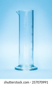 Graduated Measuring Cylinder On Blue Background