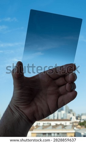 A graduated neutral density filter darkens the sky in photography 