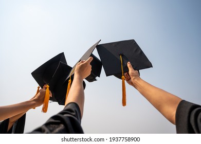 graduates student Graduation caps thrown in the Air Blue sky - Shutterstock ID 1937758900