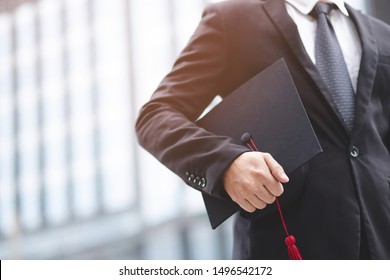 Graduates Of The University, Businessman Holding Hats Along With Success,  Filter Tone Outdoor Sunny In The Morning. Office Background. New Graduate Start Working On The First Day. Education Concept.