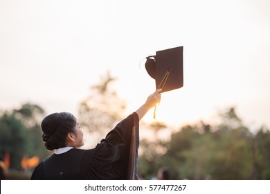 Graduates Of The University,Of Graduates Holding Hats Handed To The Sky,
Education Concept.