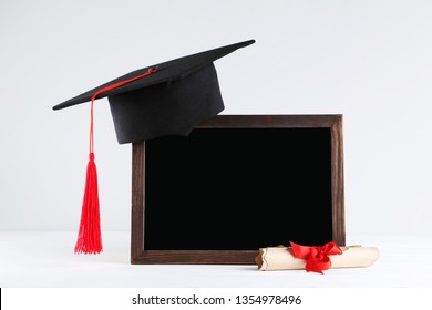 Graduation Cap With Blank Frame And Diploma On Grey Background