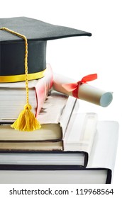 Graduation Cap And Diploma On Top Of Stack Of Books