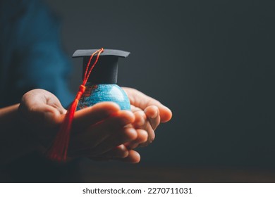 Graduation cap with Earth globe. Concept of global business study, abroad educational, Back to School. Education in Global world, Study abroad business in universities in worldwide. language study - Powered by Shutterstock